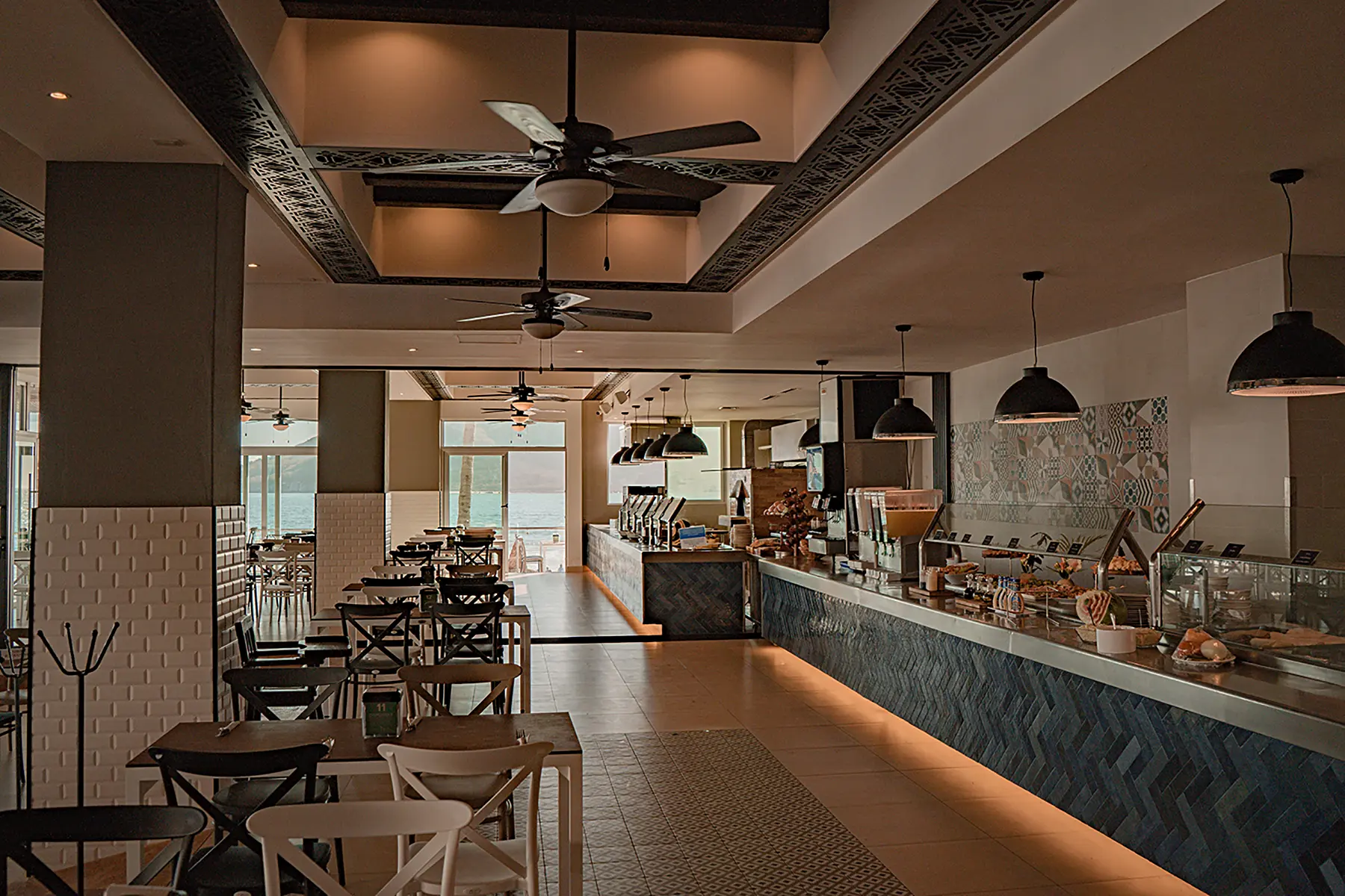 Food bar, tables, lighting of the terrace restaurant with sea views of the Oceano Palace Mazatlán hotel